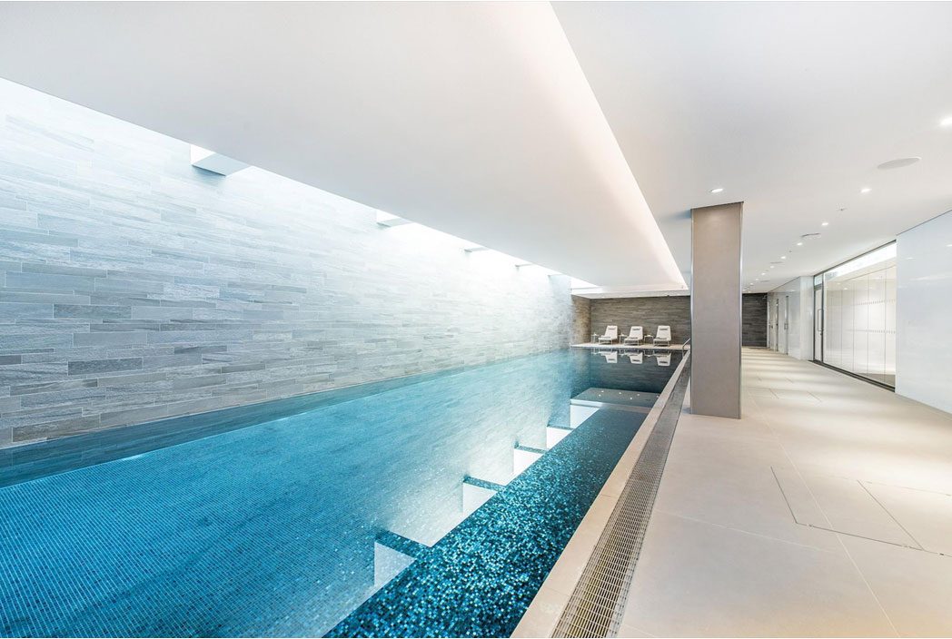 The residents' pool at Southbank Tower, a long white pool beneath the city skyline